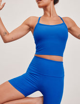 blue cropped length racerback cropped tank top with slim spaghetti straps.
